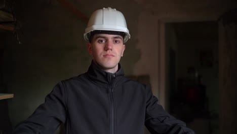 Portrait-Of-Young-House-Inspector-Puts-On-White-Hard-Hat,-Getting-Ready-For-Work