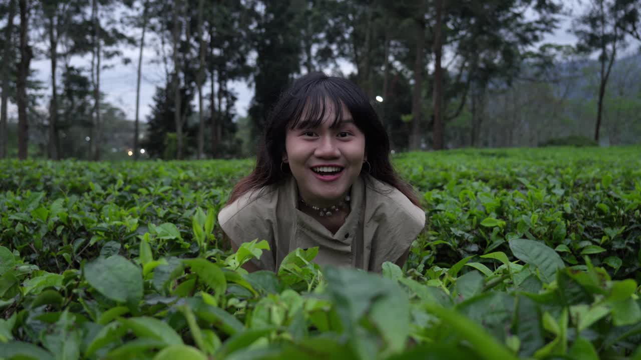Indonesian funny girl caught in a tea plantation