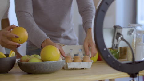 Closeup-of-young-couple-recording-video-for-cooking-vlog.