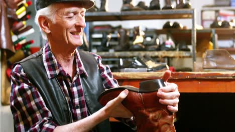 Shoemaker-examining-a-shoe