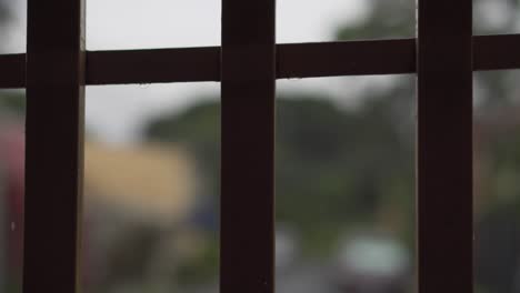 gate bars with blurry rain in background