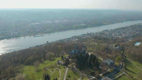 drone - aerial shot of the castle drachenburg and the river rhine with a ship siebengebirge near bonn - königswinter 30p