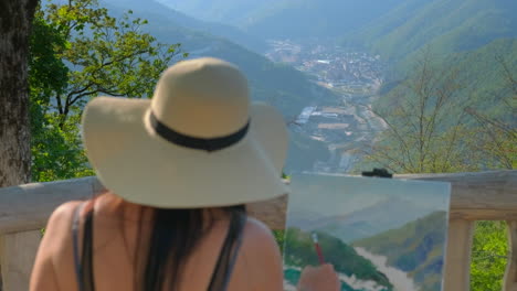 artist painting a mountain view