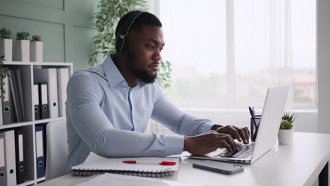 african american businessman listening music and having fun while working