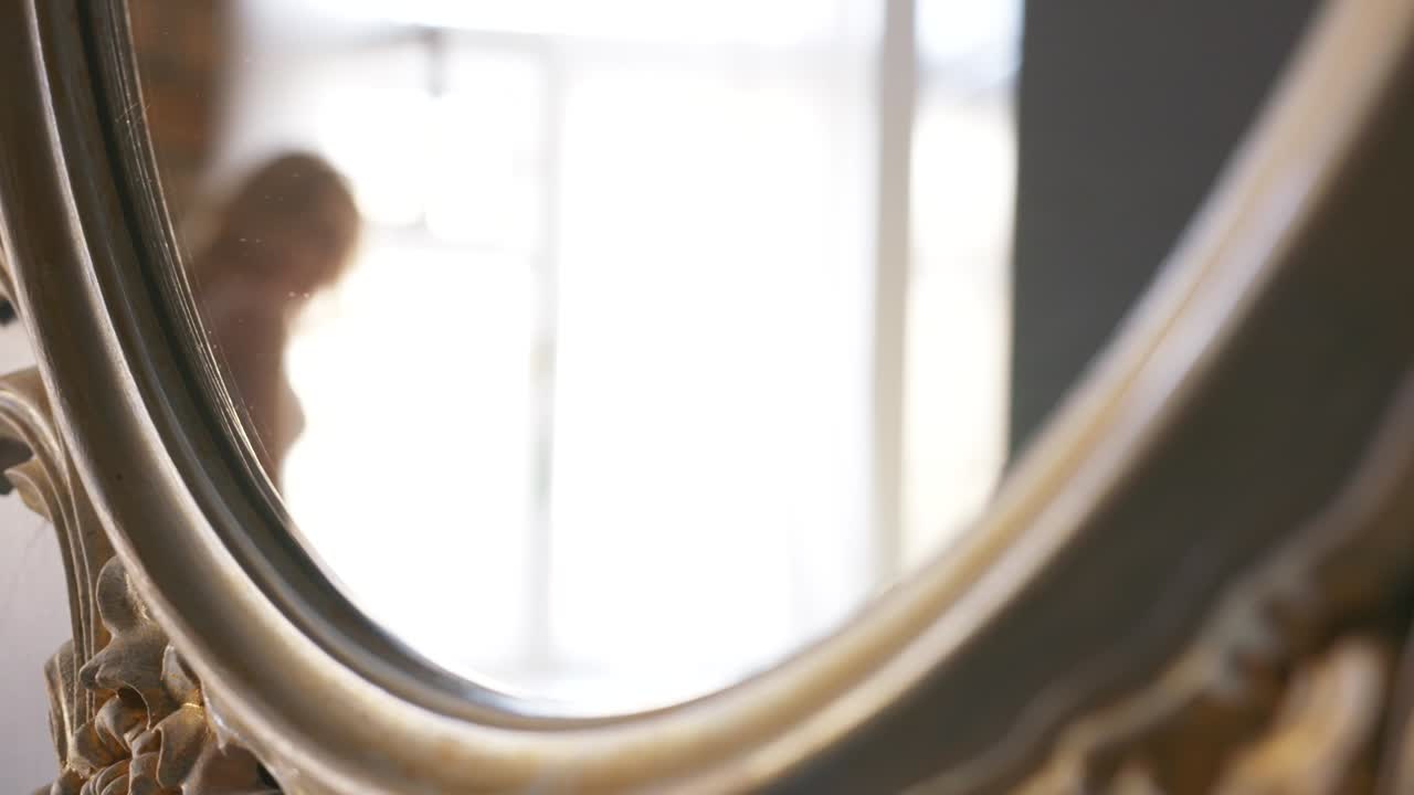 Woman looking at herself in a mirror