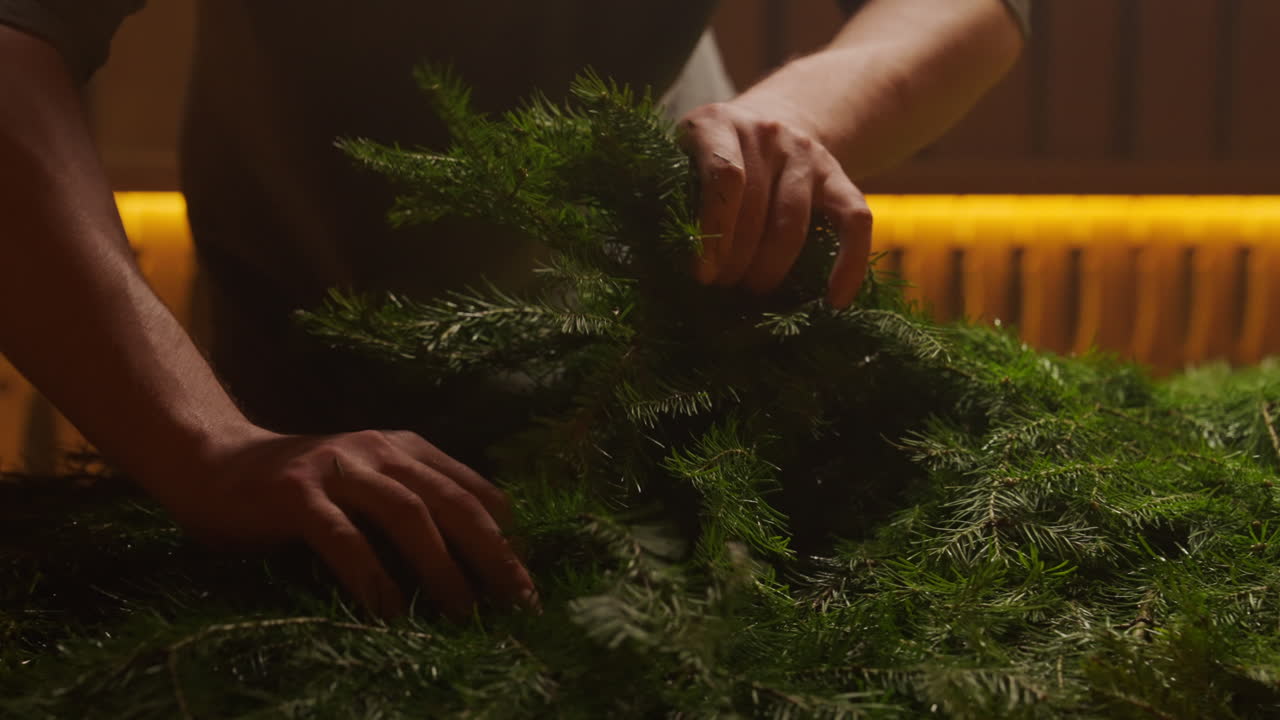 Hands arranging fresh fir tree branches