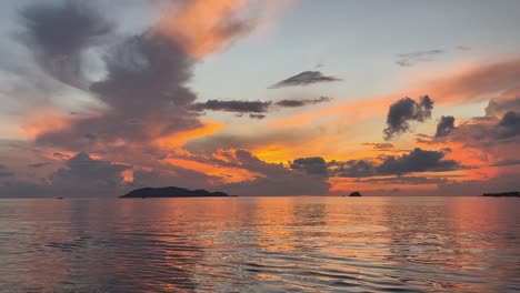 a small boat sails towards the sunrise, on a journey towards new horizons, as the warm light of the sun illuminates the calm waters