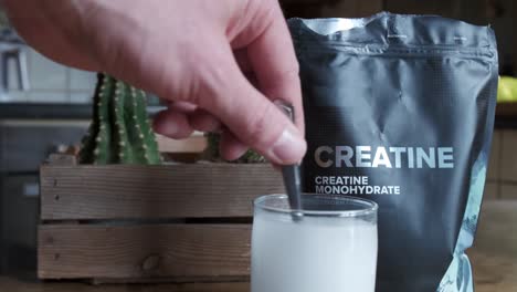 Close-up-of-a-hand-mixing-creatine-monohydrate-in-a-glass-4K-slow-motion