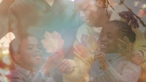 animation of happy african american family outdoors over leaves