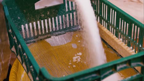 pouring dry powder paraffin trough a mesh in slow motion