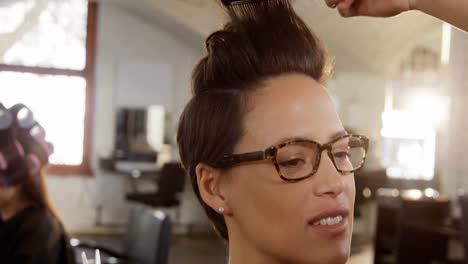 male hairdresser styling customers hair