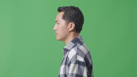 side view close up of asian man walking in green screen background