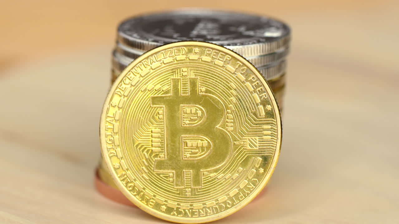 Golden and silver bitcoin crypto money with old dollar coins, close up, graphic video card mining