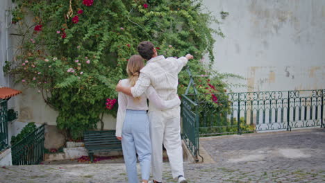 loving couple cuddling tenderly at urban place. enamoured pair embracing at city