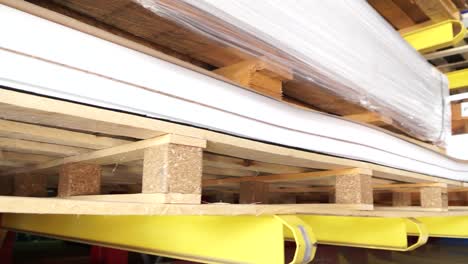 pallets of white sheets in a warehouse