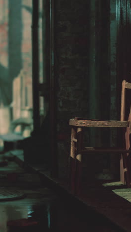 a lone wooden chair in a dark, empty room