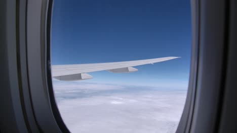 passenger airplane wing in flight seen from cabin window