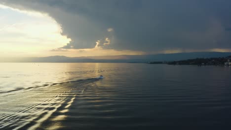 following motorboat with drone at sunset