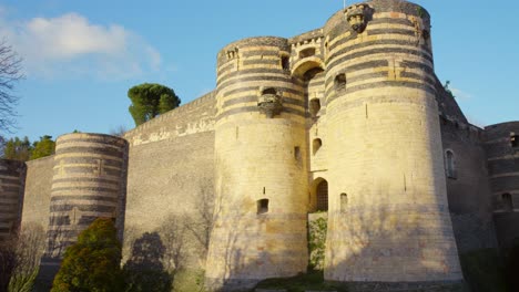 towers of castle of angers in france on a sunny day - low angle