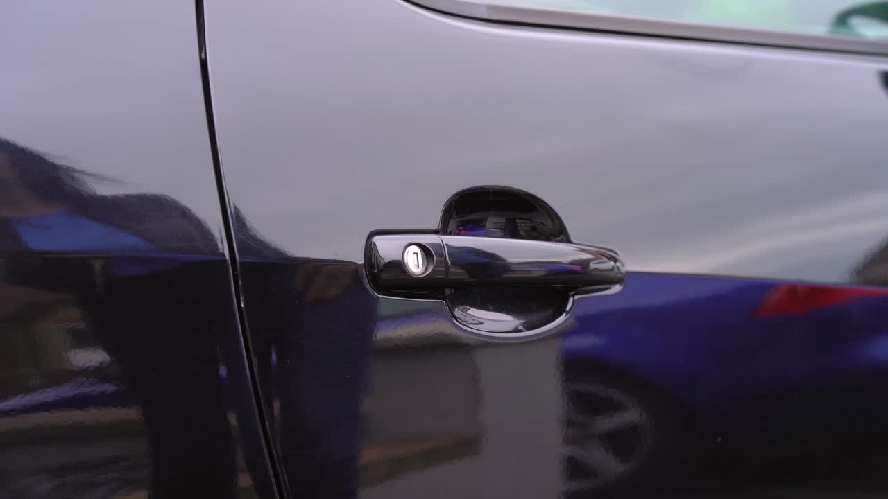 Car door unlocking with bunch of keys in womans hand