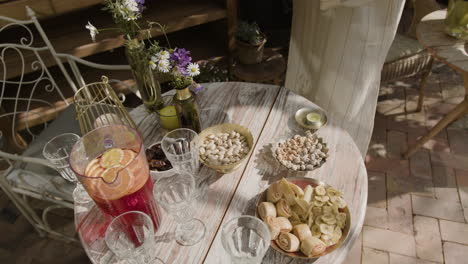 person arranging snacks and drinks on an outdoor table