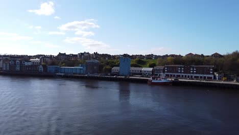 view of the rivershore as seen from the ferry leaving newcastle upon tyne, england