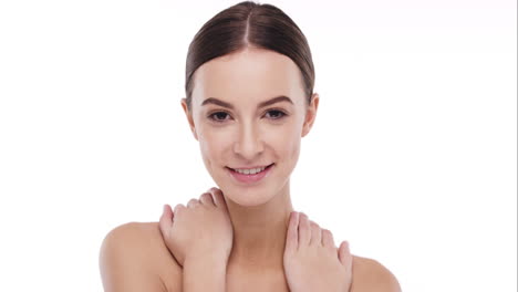 Beauty-portrait-of-woman-touching-beautiful-face-in-slow-motion-skincare-concept-on-a-white-background