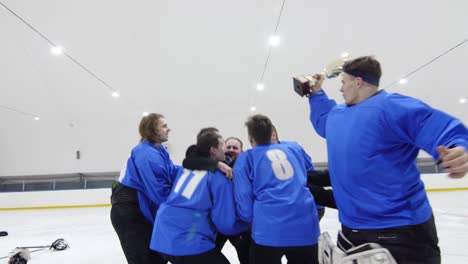 hockey players tossing coach and celebrating victory