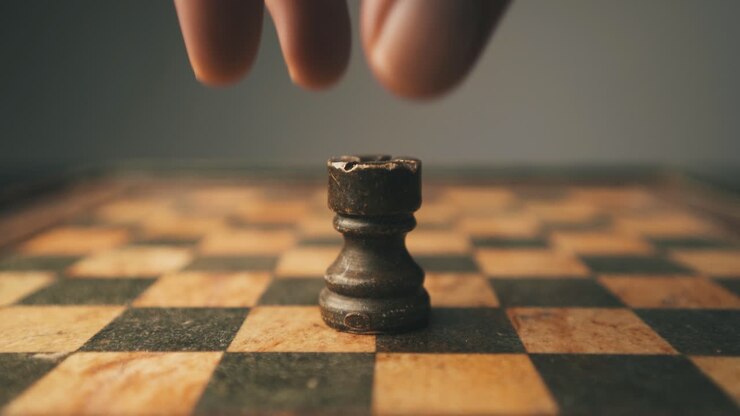 Close-up shot of rook chess piece being placed on game board