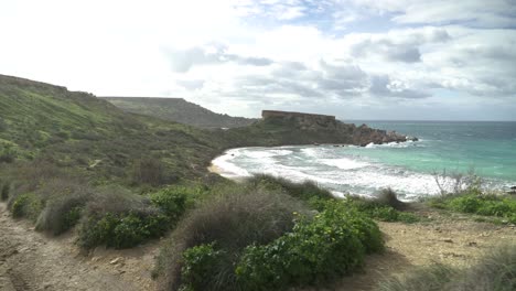 turquoise colour mediterranean sea rolling waves to shore on a windy day in winter