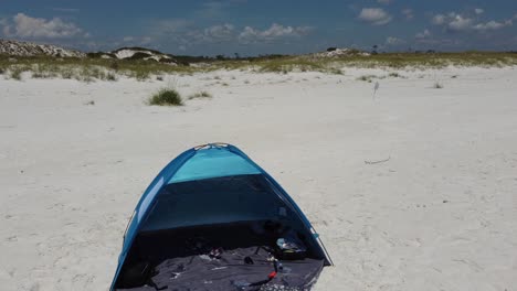 Empty-blue-color-beach-tent-on-white-sandy-beach-in-Shell-island,-panama-city-beach,-Florida