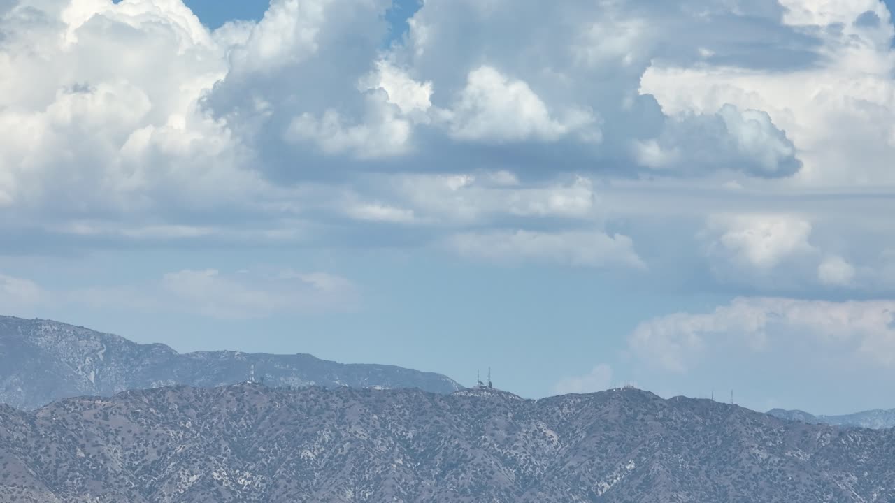 Hillside with storms rolling in clouds