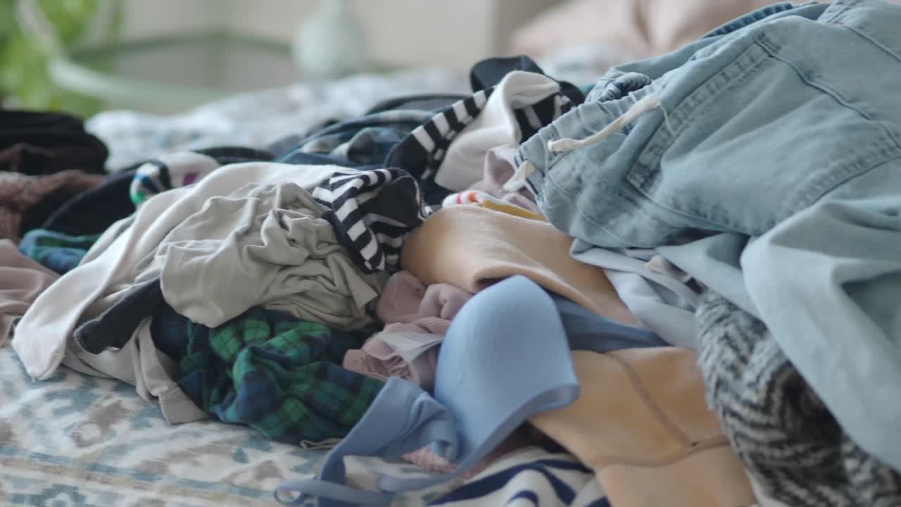 Close Up of a Pile of Clothes on a Bed