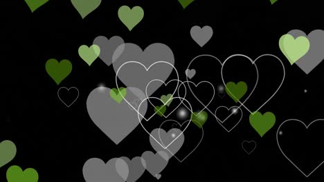 Animation-of-green-and-grey-hearts-floating-on-black-background