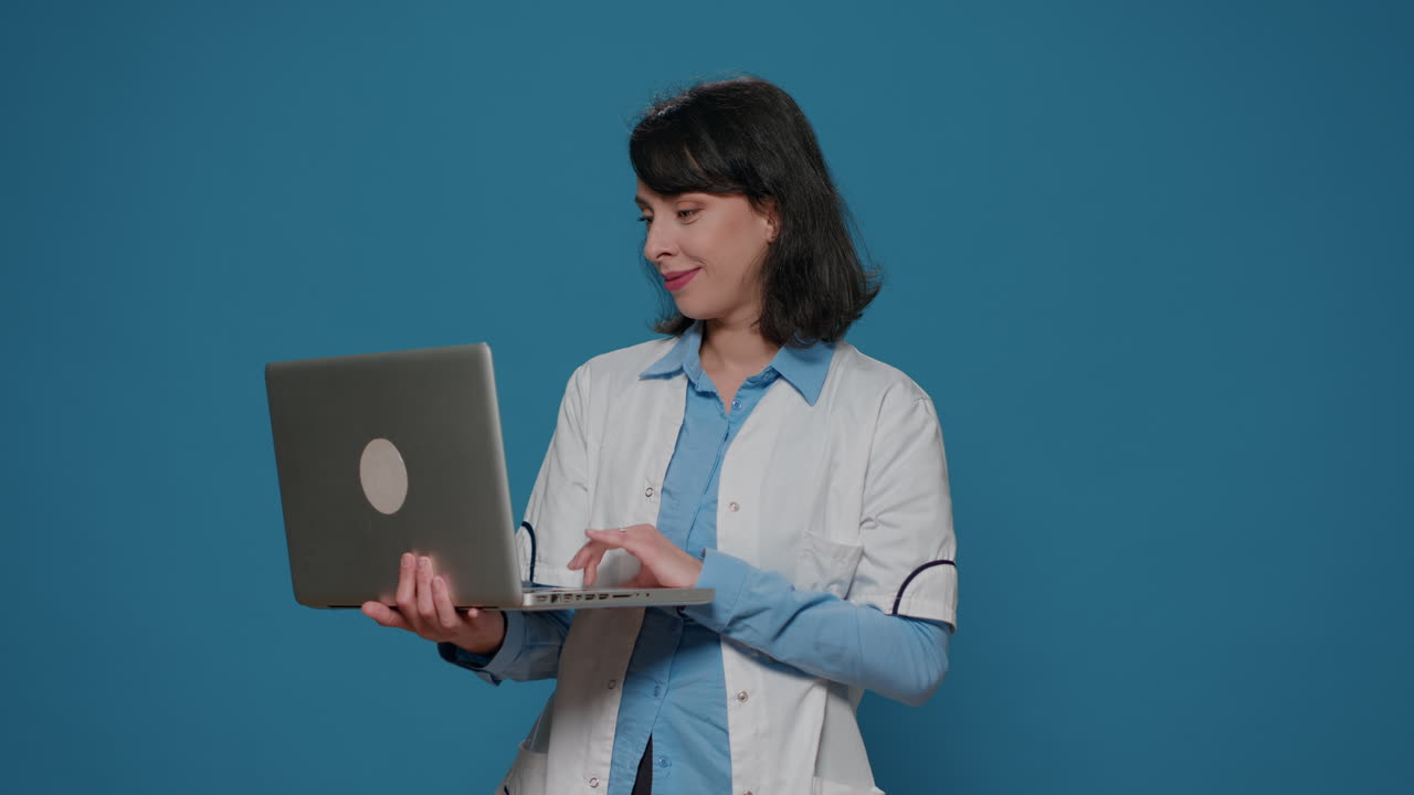 Microbiology chemist doing research work on laptop in studio