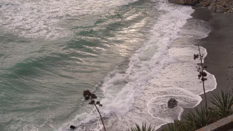 Looking-down-towards-beach-with-big-waves-crashing