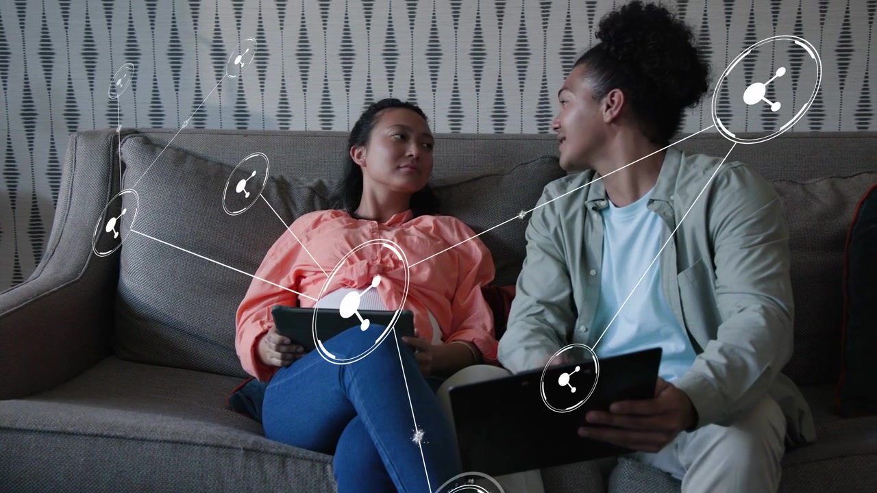 Man tapping tablet couple sitting on sofa leaning sharing screens, network linking devices to agree