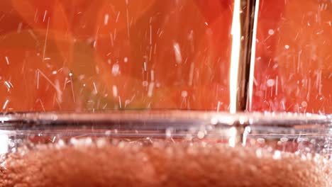 Glass-of-cola.-Ice-cola-with-splashing-bubbles-slow-motion-on-a-blurry-light-,blurry-background.