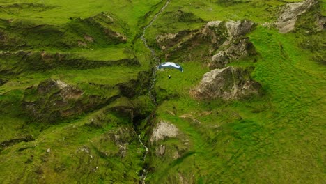 paragliding over green mountains