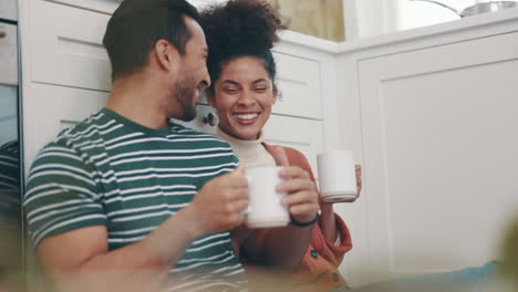Couple-relax-on-floor-of-kitchen-with-coffee