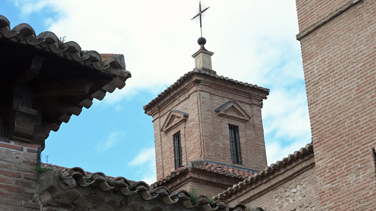 Guadalajara, Spain: A historic church tower, built from traditional brick, symbolizes centuries of architecture. Its weathered facade and embody deep Spanish heritage and timeless spiritual legacy.