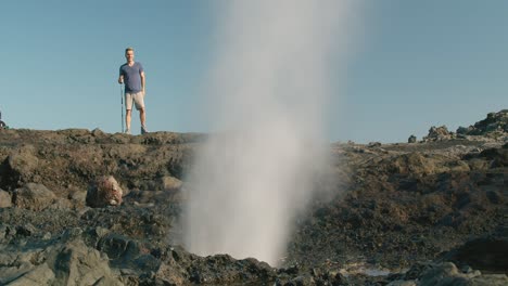 male traveler walking near blowhole