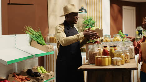 local vendor placing crates with freshly harvested fruits on grocery store