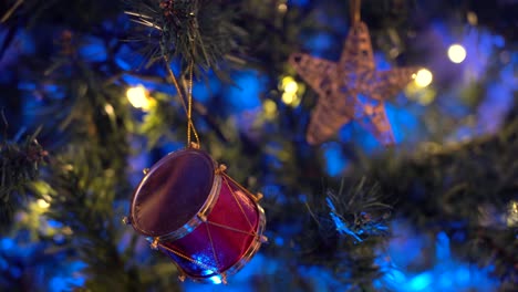 christmas tree decorated with drum shaped toy and garland