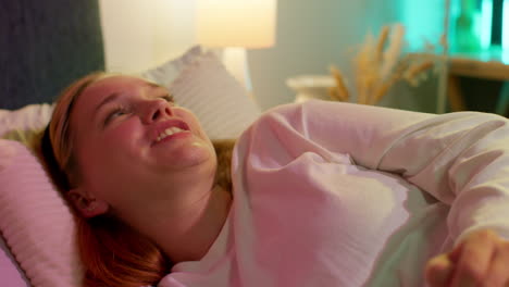 woman laughing in bed